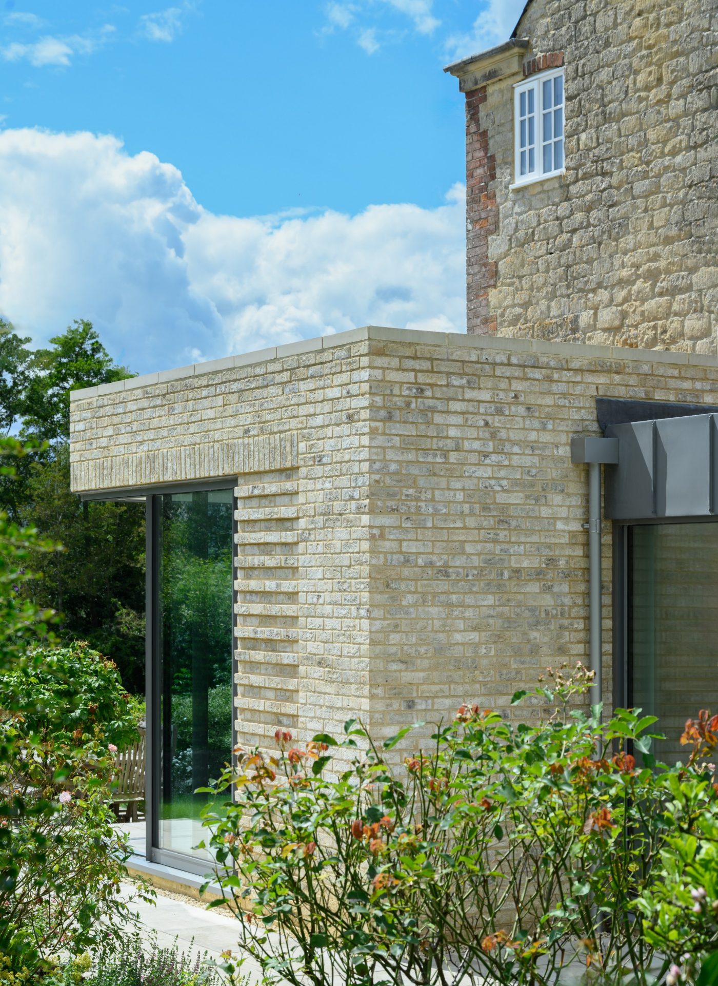 Buff extension with large windows and blue sky in the background