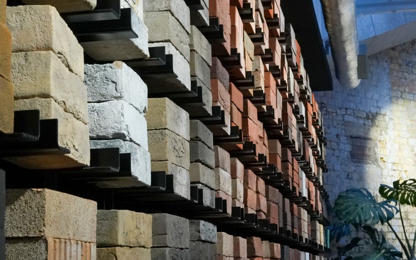 Tall wall full of different coloured bricks for competitors to pick and draw on