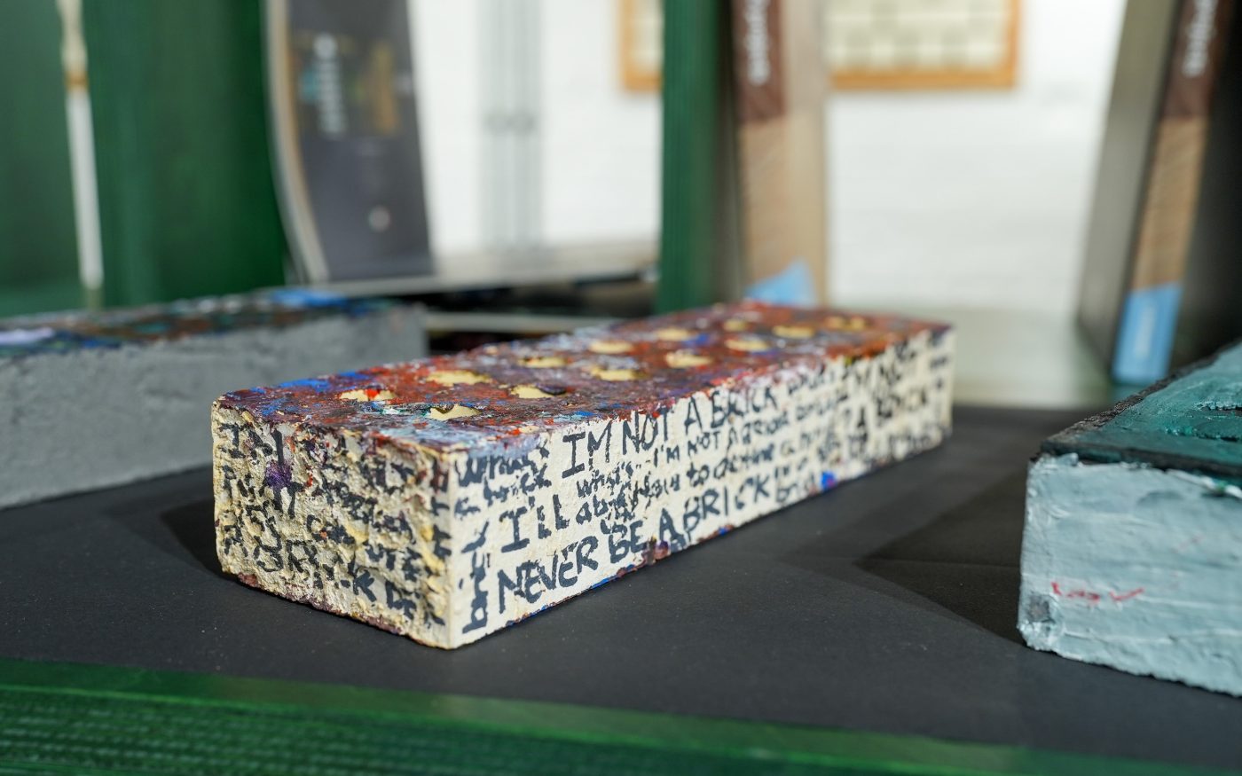 Brick covered in writing around the sides