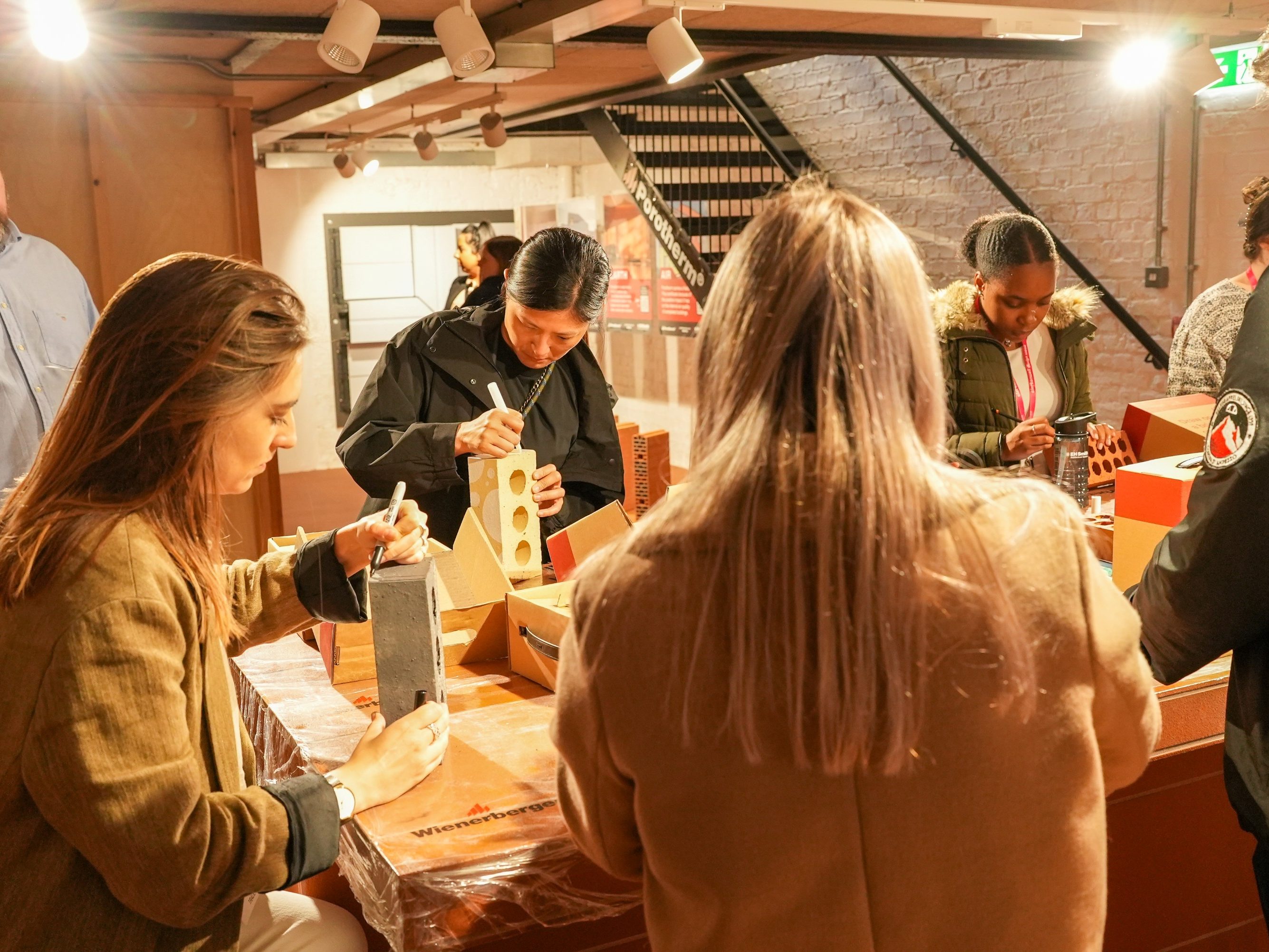 Bricks displayed on table that have been creatively decorative in different styles