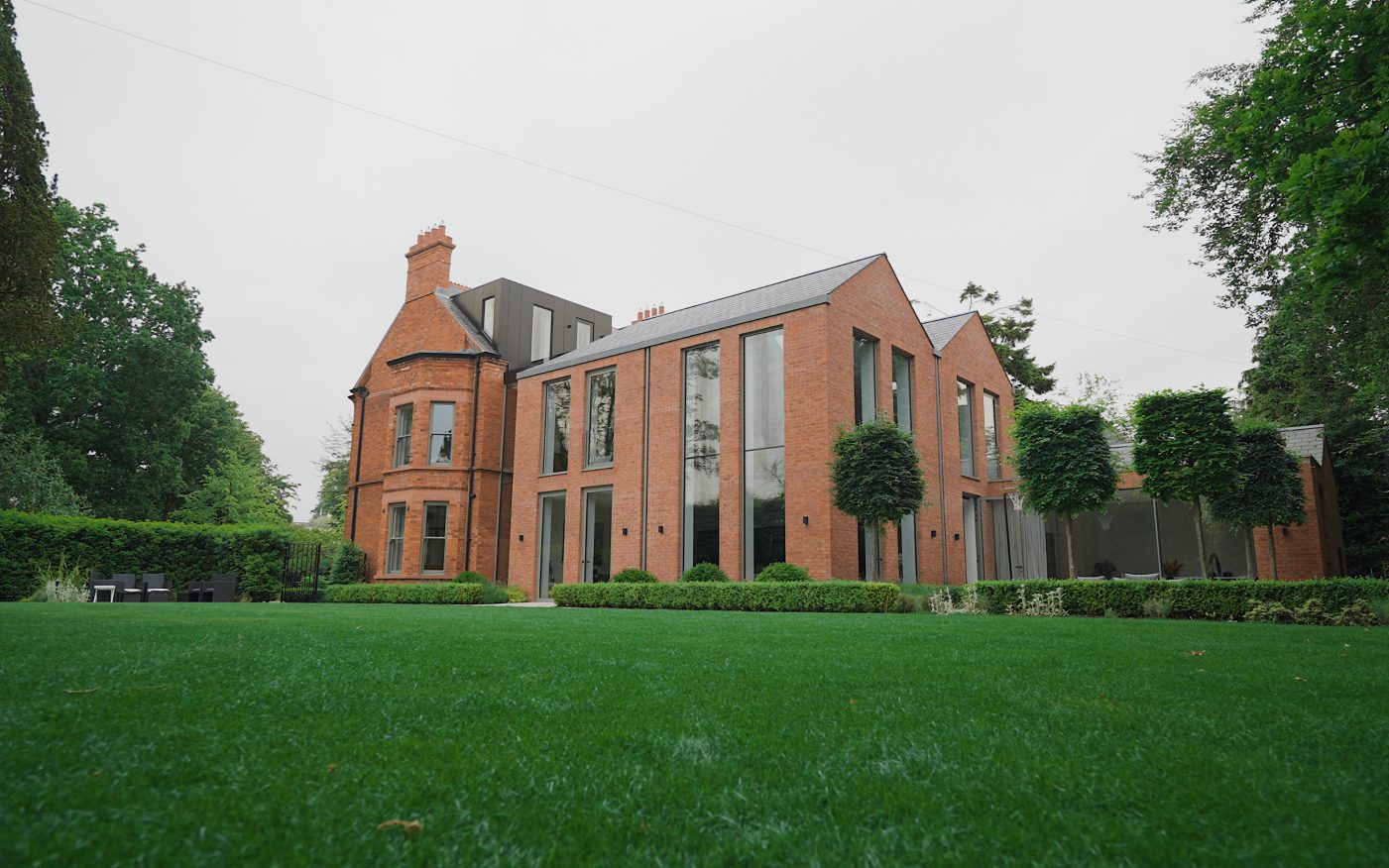 Beautiful red brick home with surrounding greenery