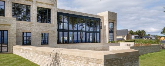 Huge buff brick property with stunning greenery surrounding it