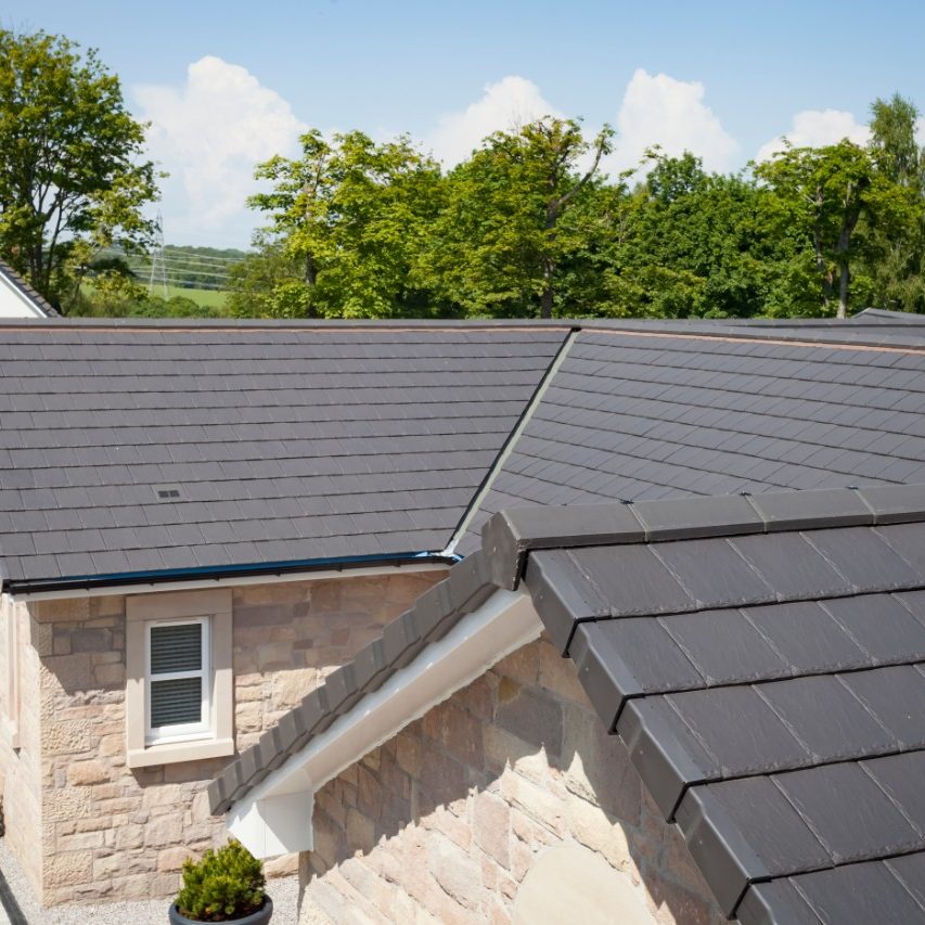 Grey roof tiles on buff brick home