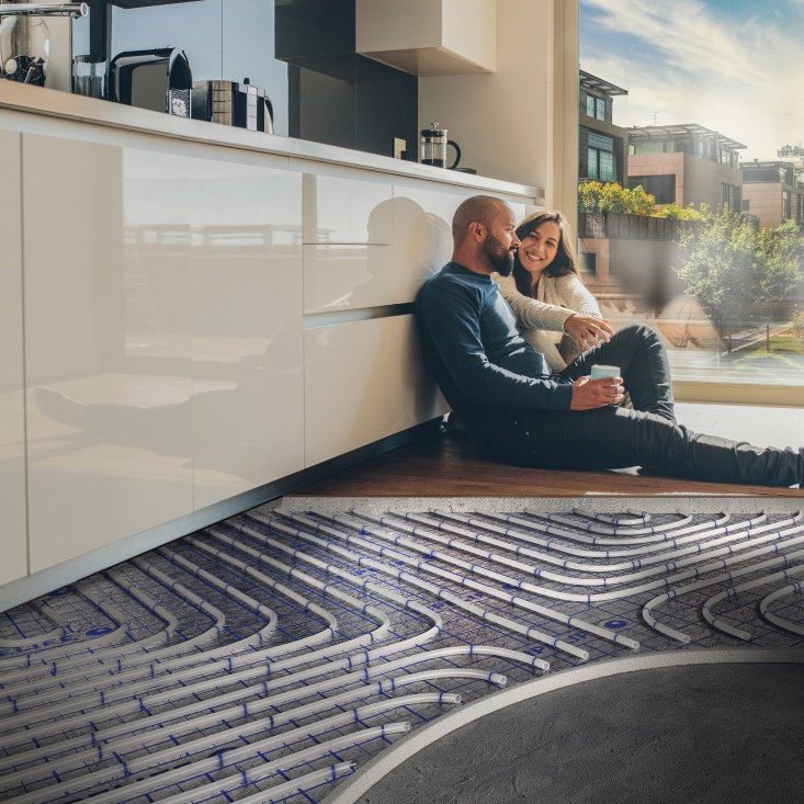 Man and women sat in the kitchen with underfloor heating fitted