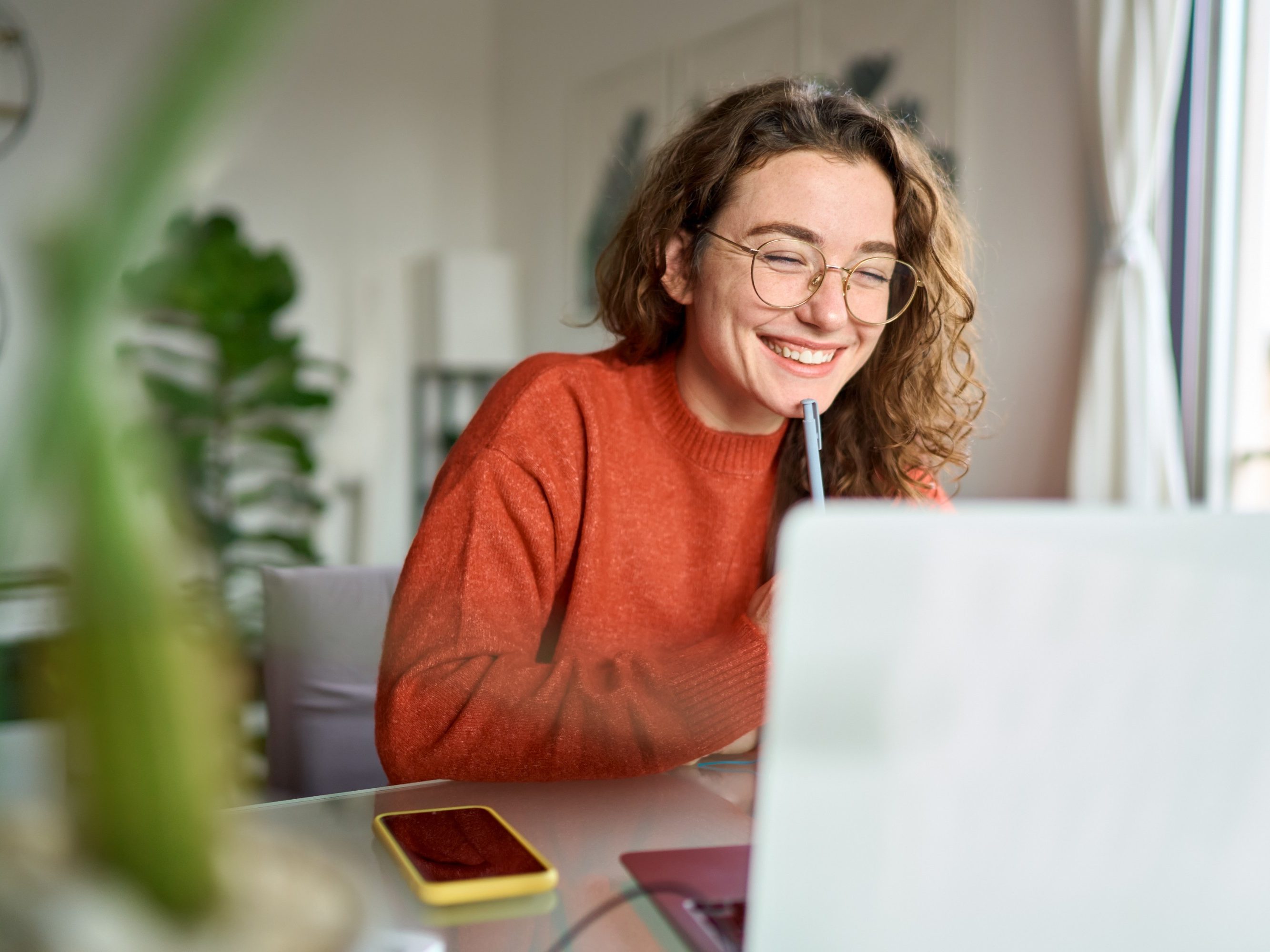 Women smiling towards her laptop