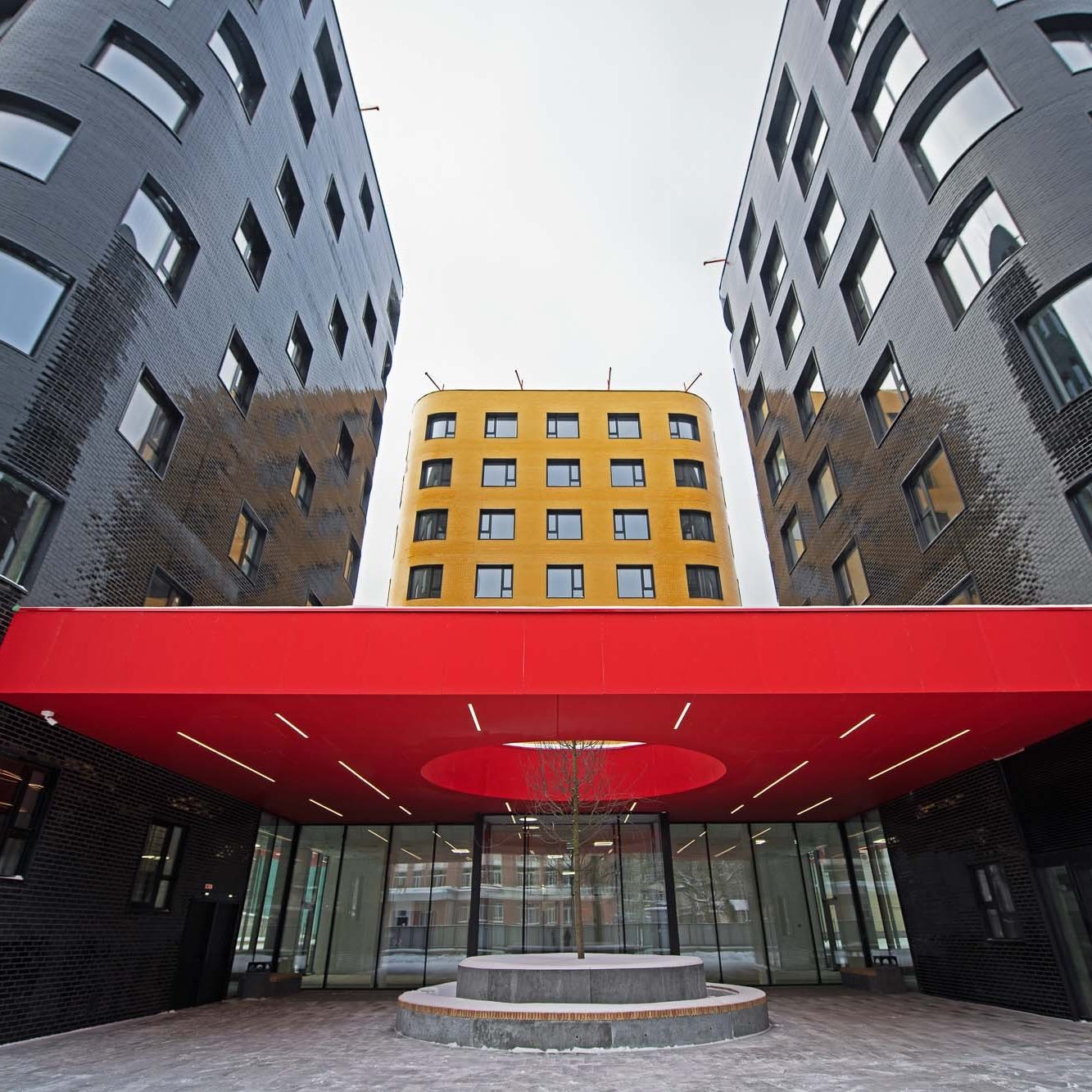 Modern brick house at dusk with lighted windows