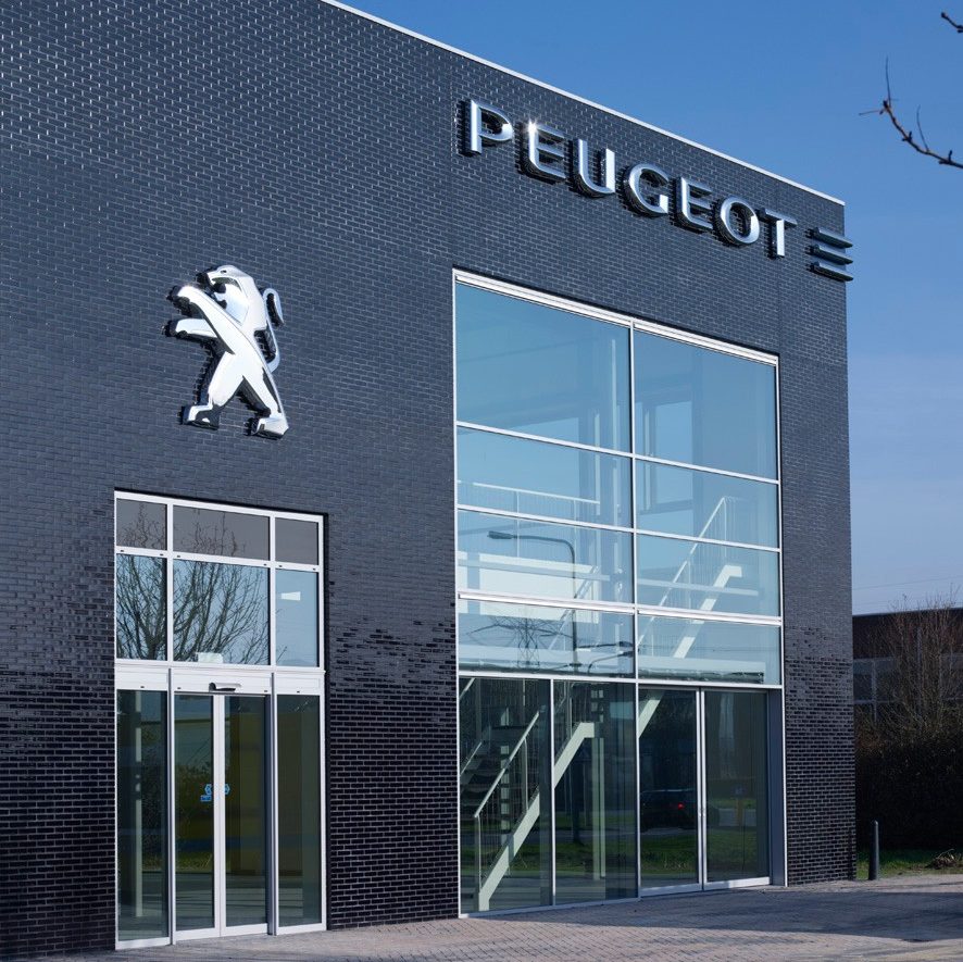 Peugeot logo on glazed brick facade