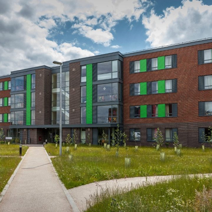 Modern brick house at dusk with lighted windows