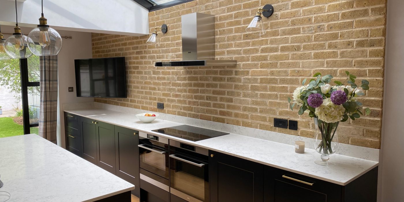 Modern kitchen with large skylight and brick slip wall