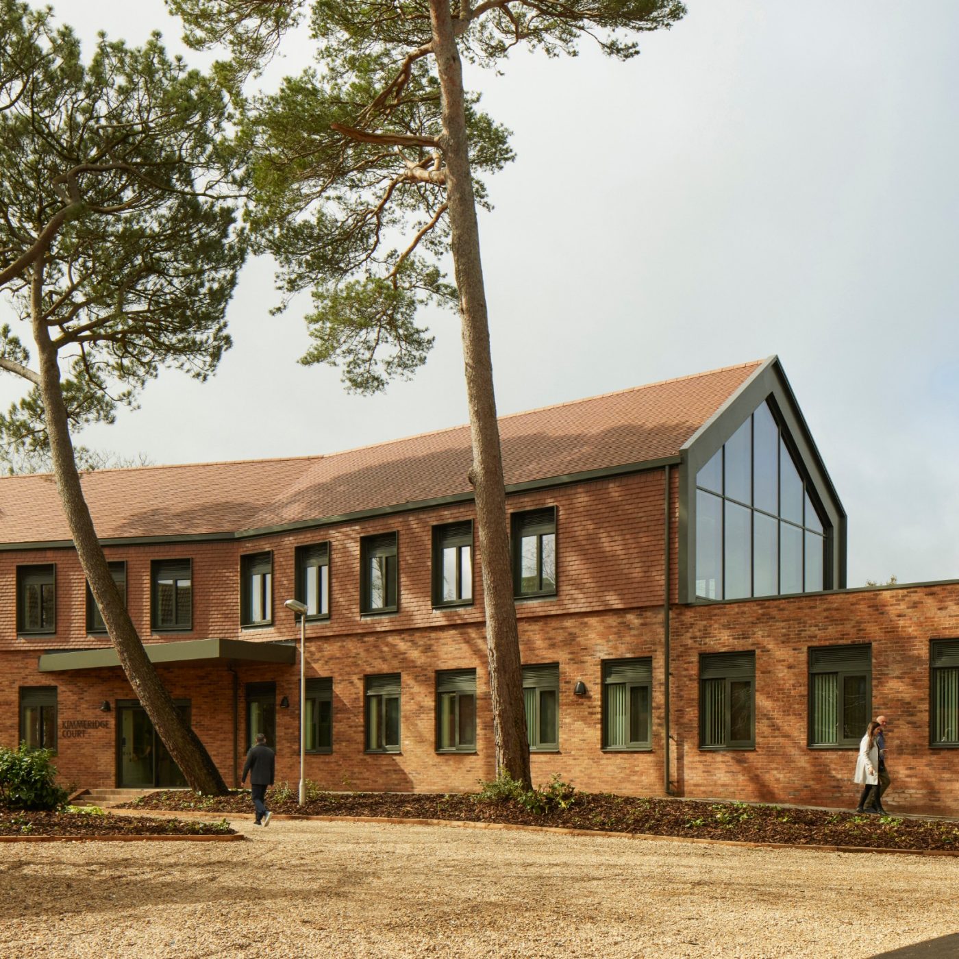 Modern inpatient facility with tall trees