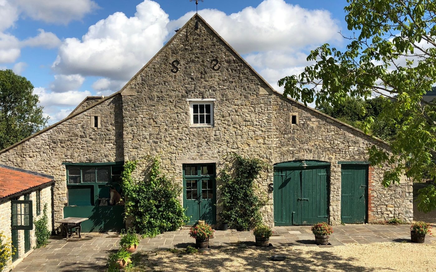 Old farmhouse with green doors