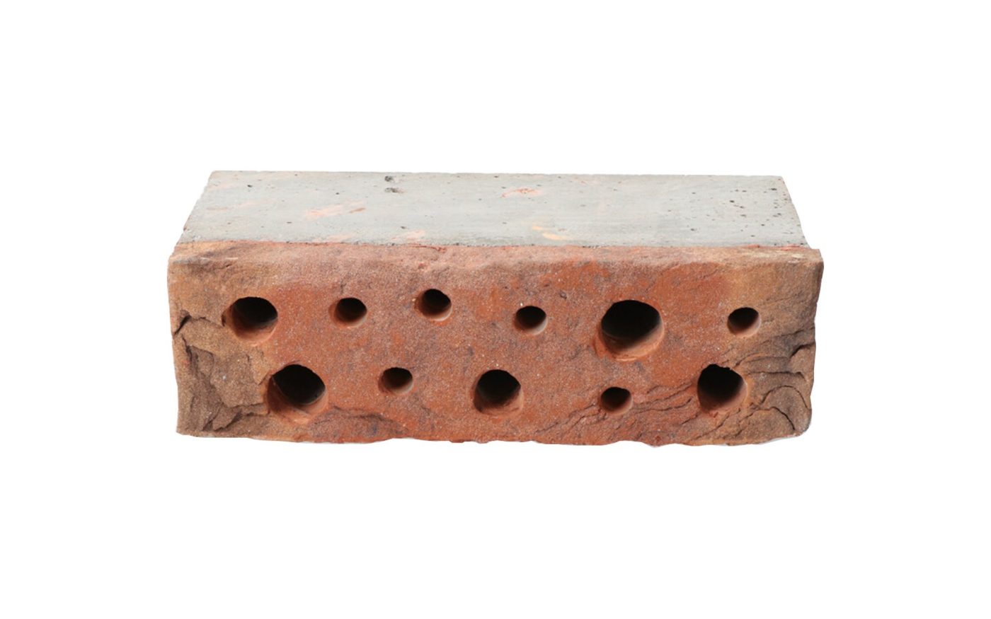 Side view of bee brick, drilled with holes for bees