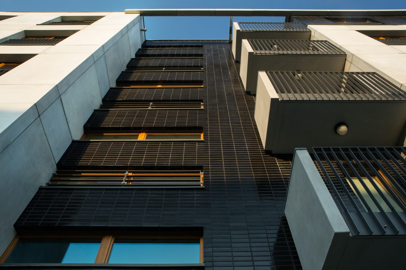 Multifamily setting with black glazed facing brick slips in Crakow