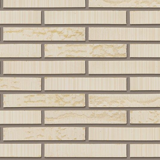 White brick wall with brown/grey mortar