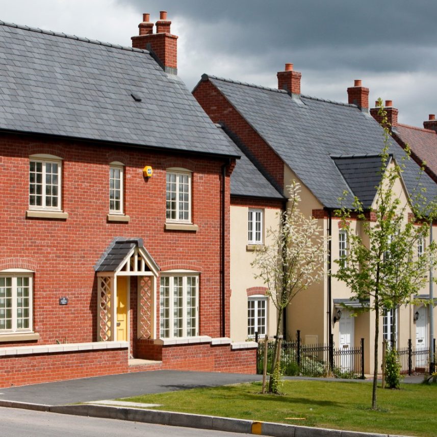 Modern brick house at dusk with lighted windows