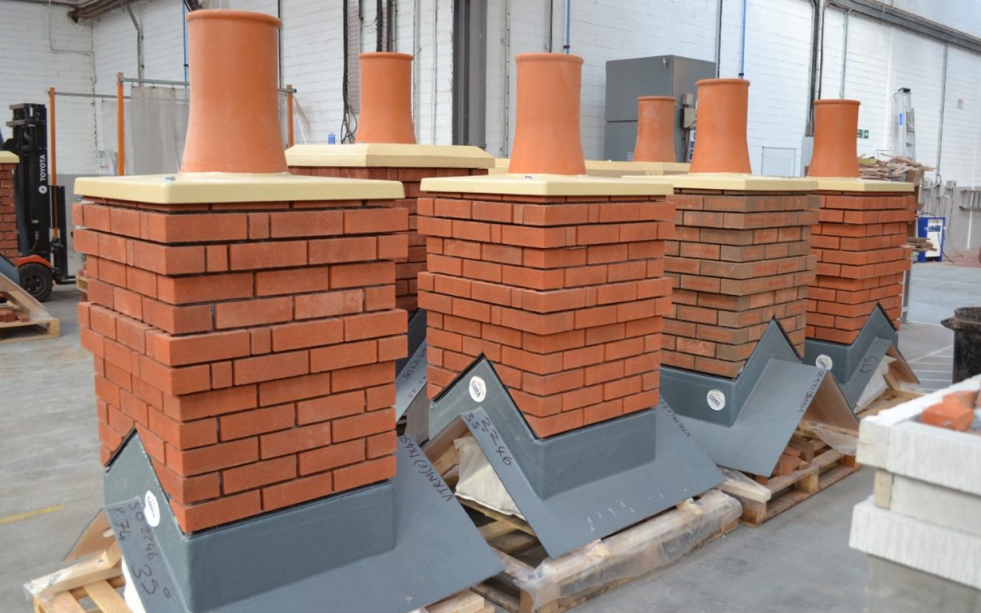 Prefabricated chimneys on pallets in factory
