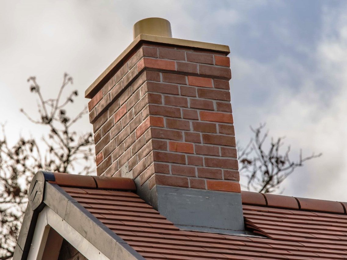 GRP chimney on red tiled roof