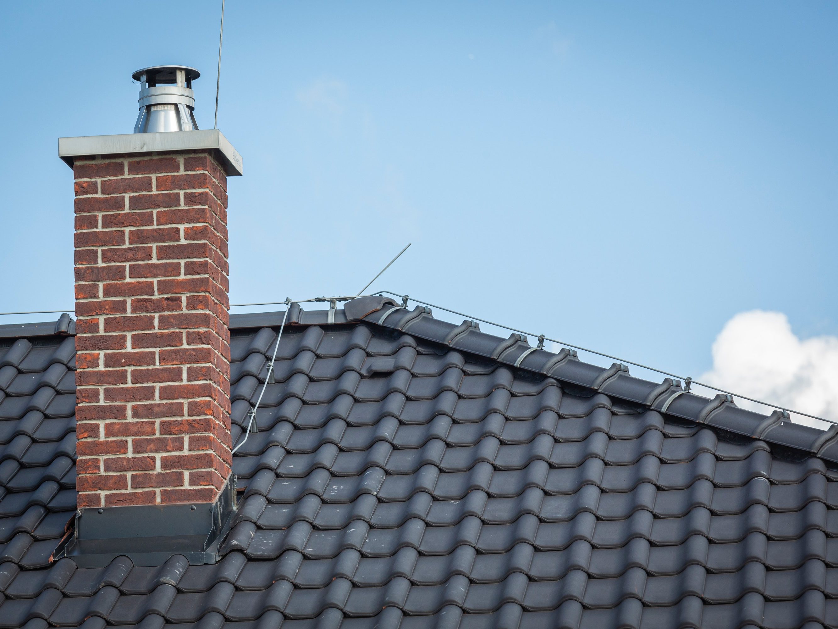 Brick clad chimney against blue sky