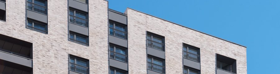 Corium clad residential building against a blue sky