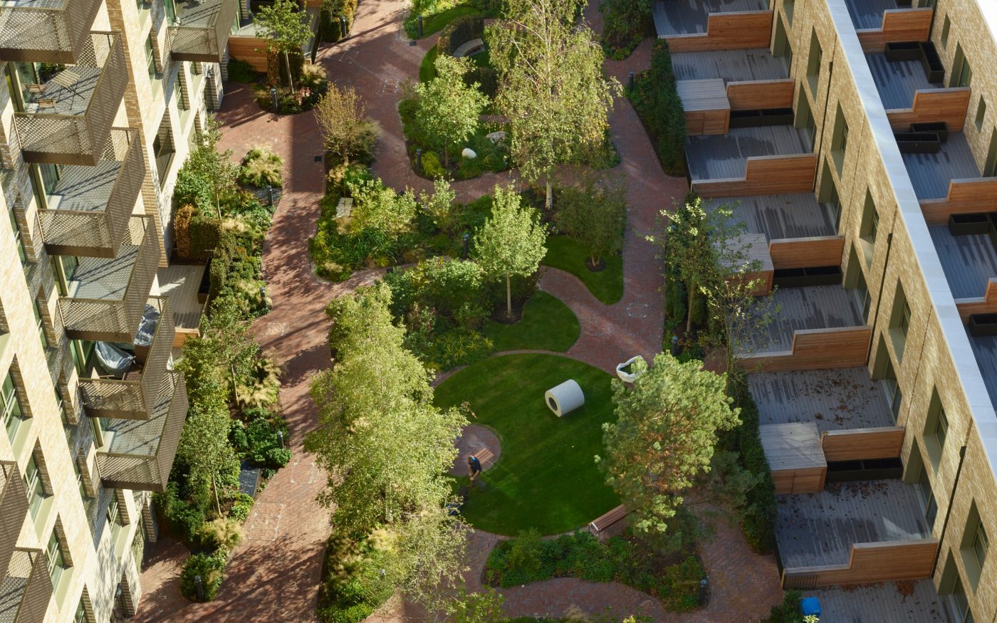 Aerial view of a lush park in modern London housing development