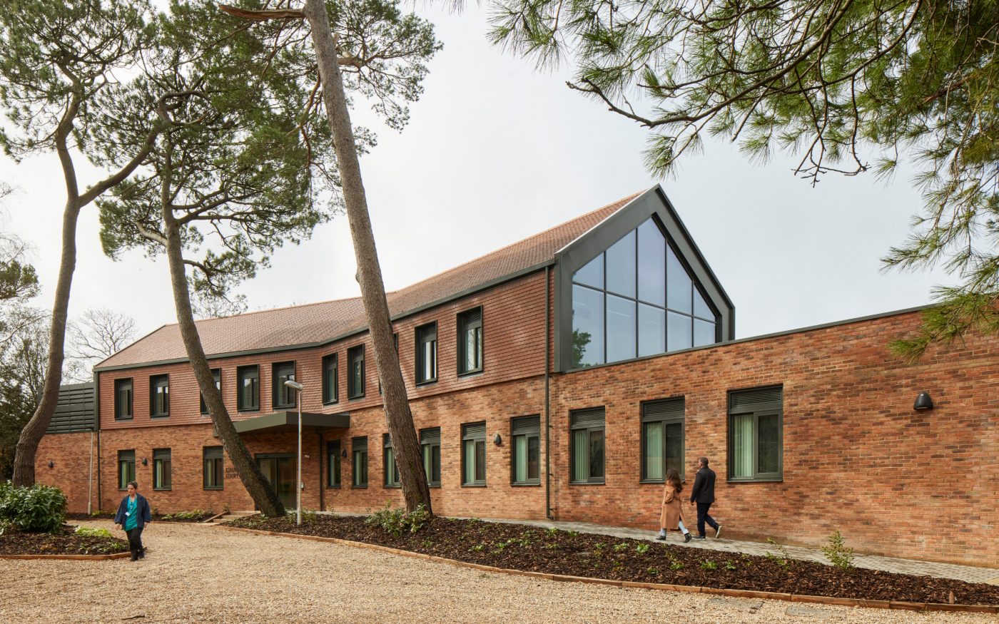 Exterior of modern healthcare facility with brick walls and vertical tile cladding