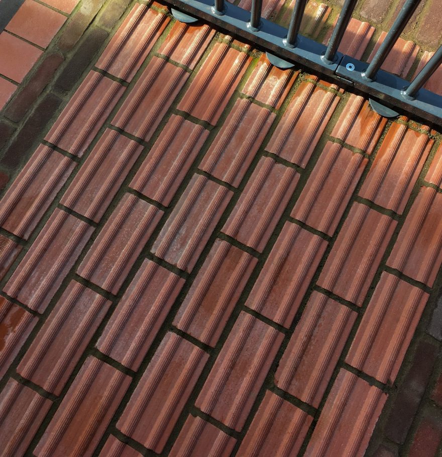 Red clay pavers with ridges to warn pedestrians of potential hazards