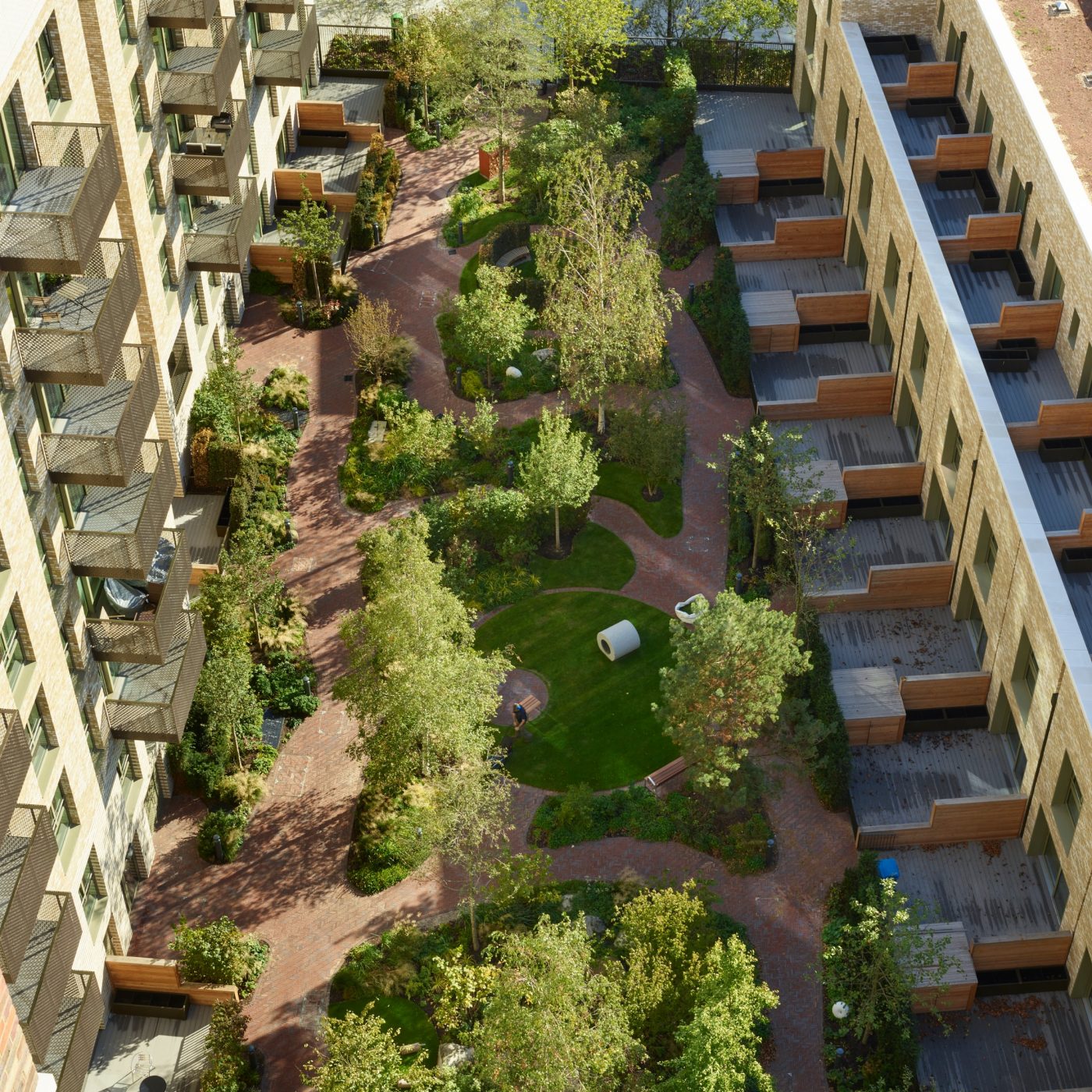 Aerial view inner city park with trees and clay paver paths