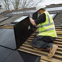 Man on roof installing solar array
