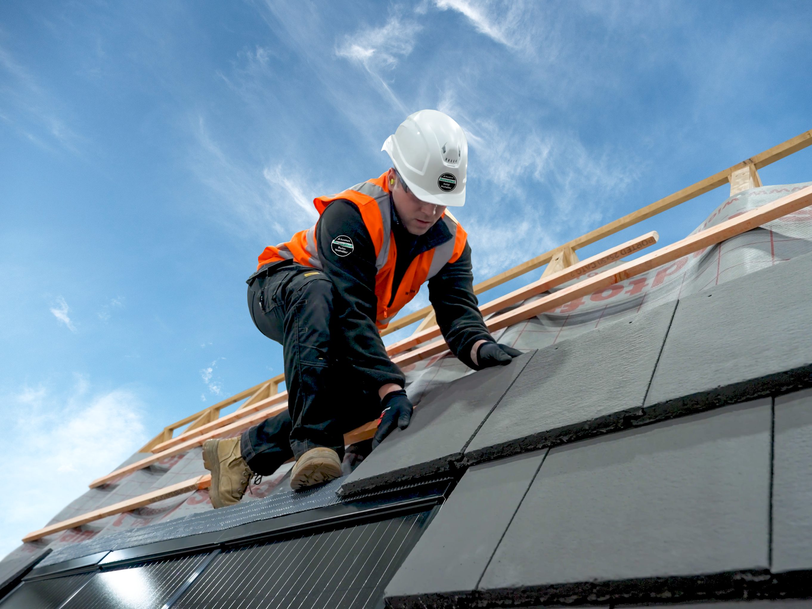 Man installing in-roof solar panels