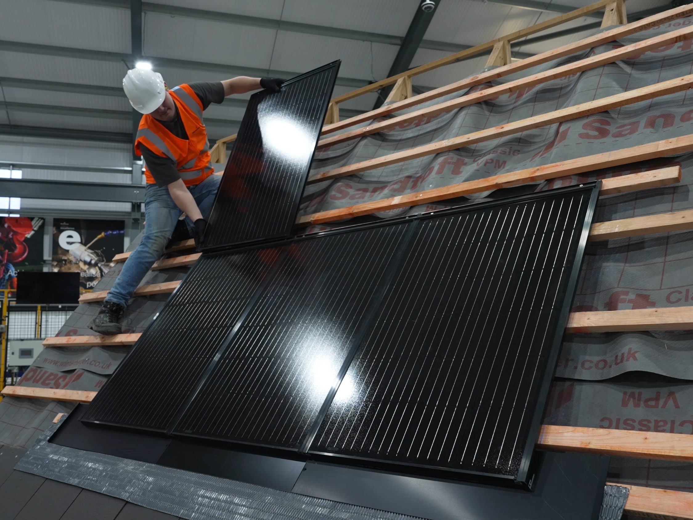Man installing in-roof solar panels