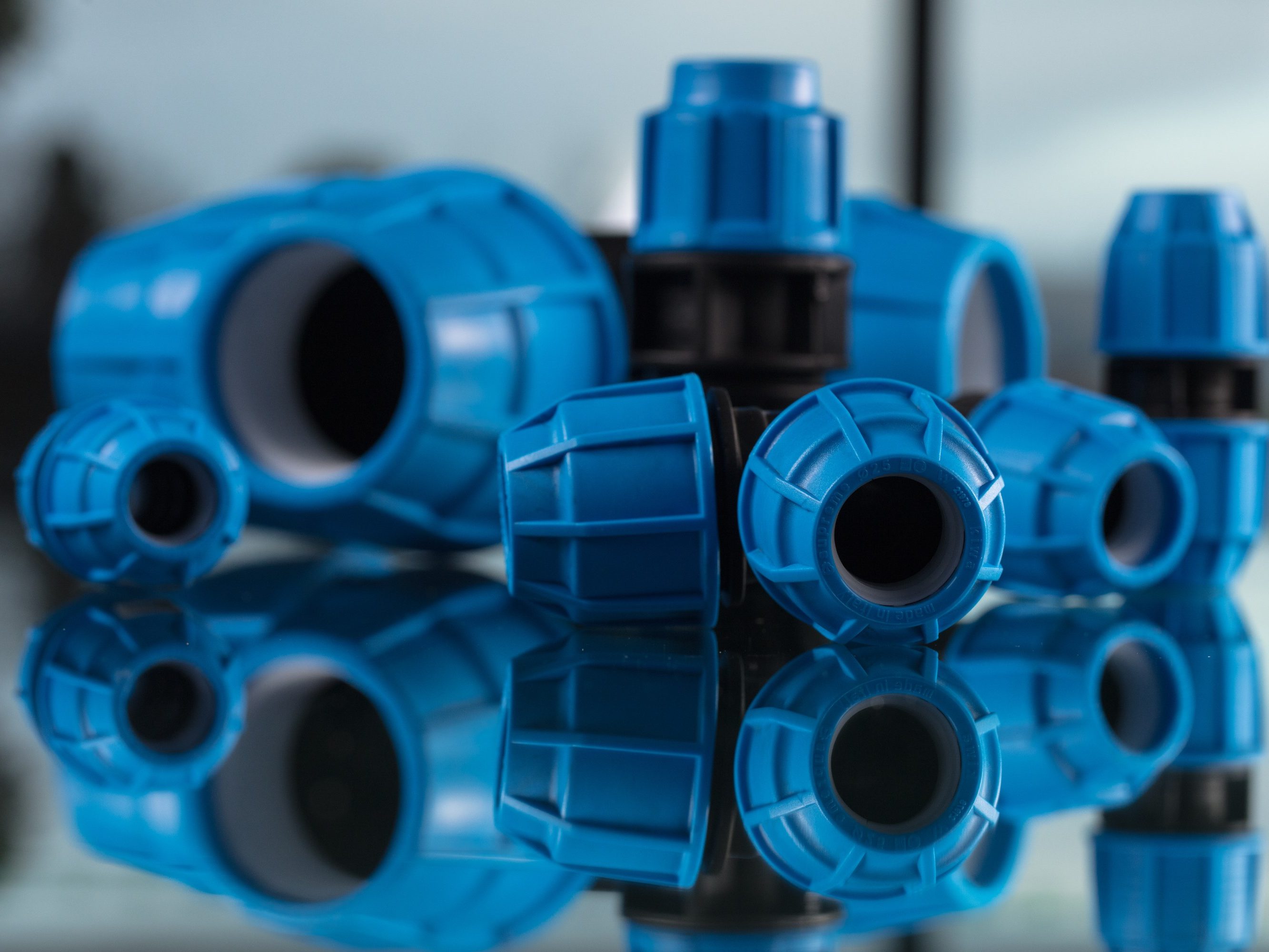 Blue pipe products on a mirrored surface