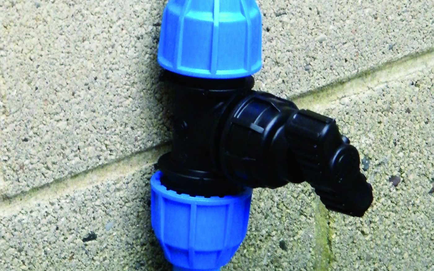 Blue and black mains water supply system fitted to a wall