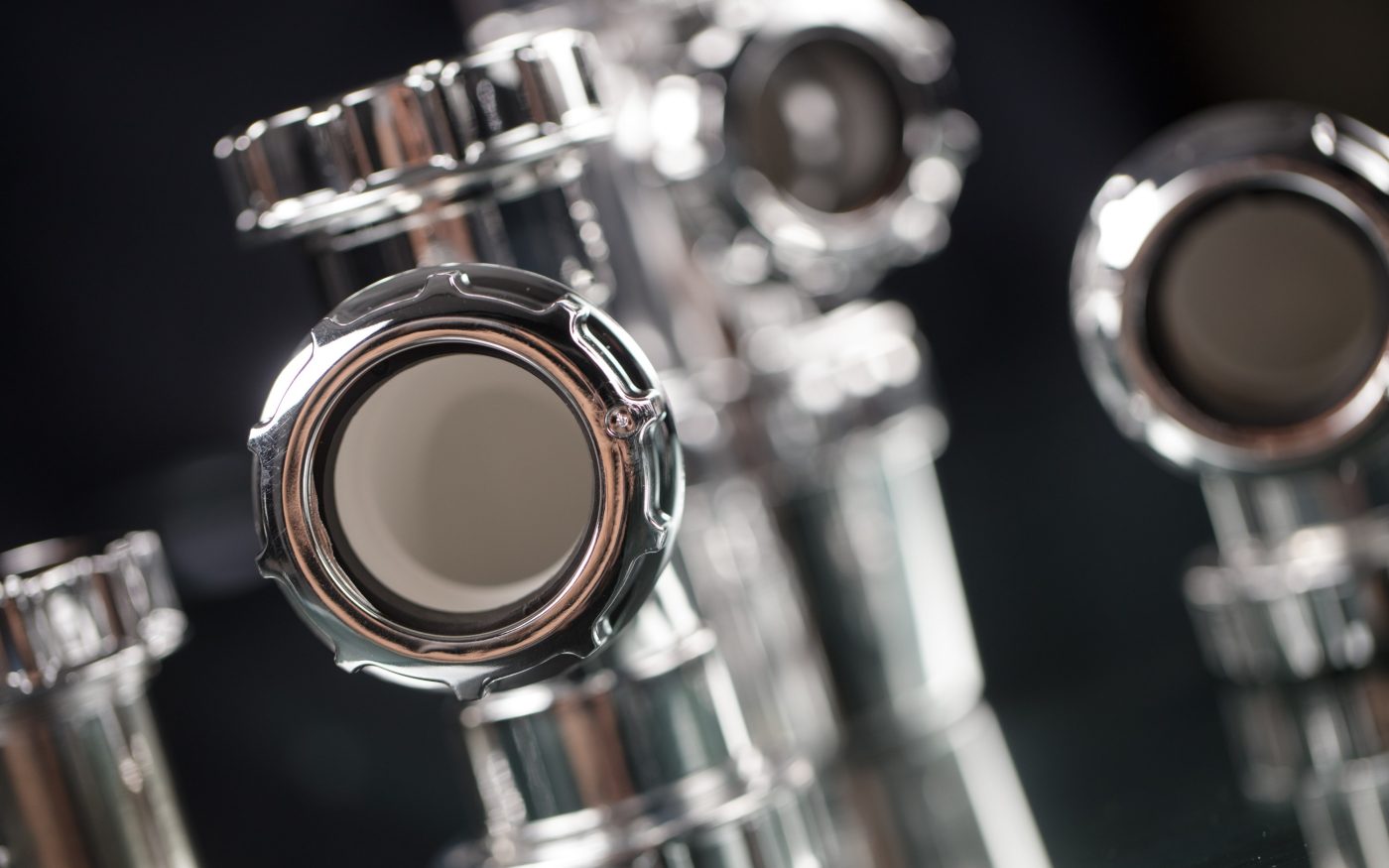 Highly polished chrome pipe fittings arranged in a group