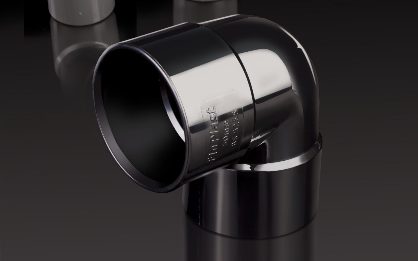Black glossy plastic pipe displayed vertically