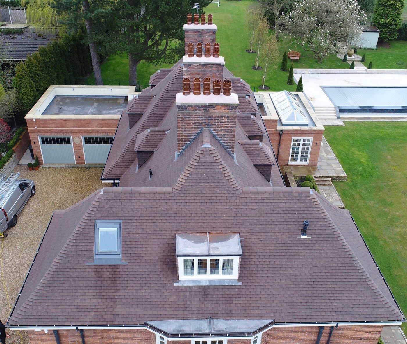Traditional residential building with Wienerberger's Barrow roof tiles, a garage and garden in the background