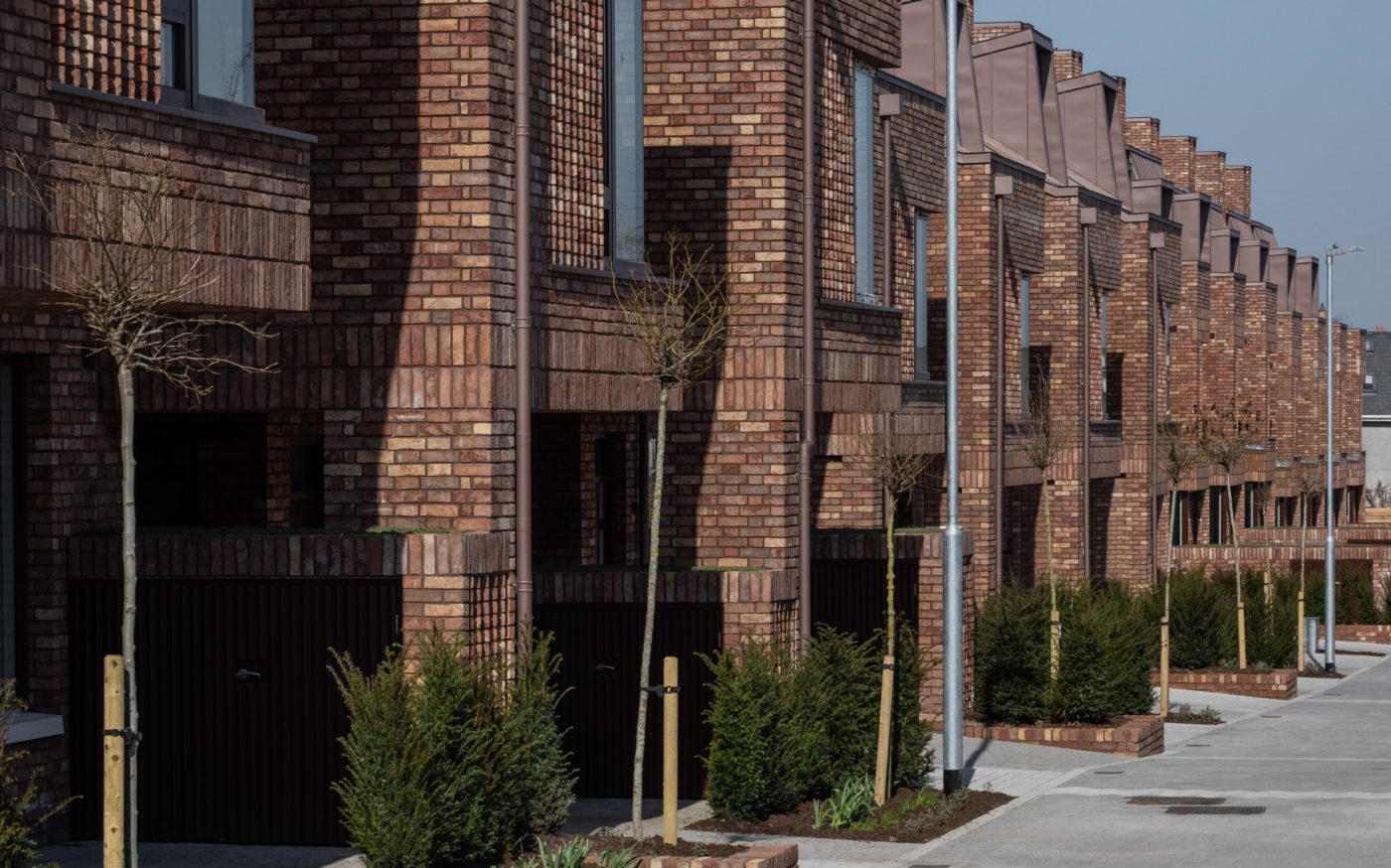 Row of modern terraced houses with brick walls