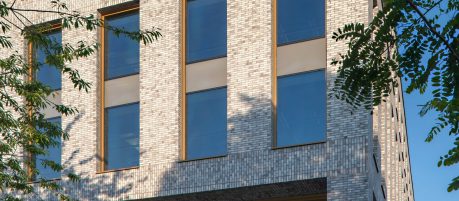 Close view of light grey Corium brick cladding of the Base building