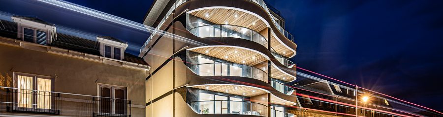 Exterior of Seaton Beach contemporary apartment building at night