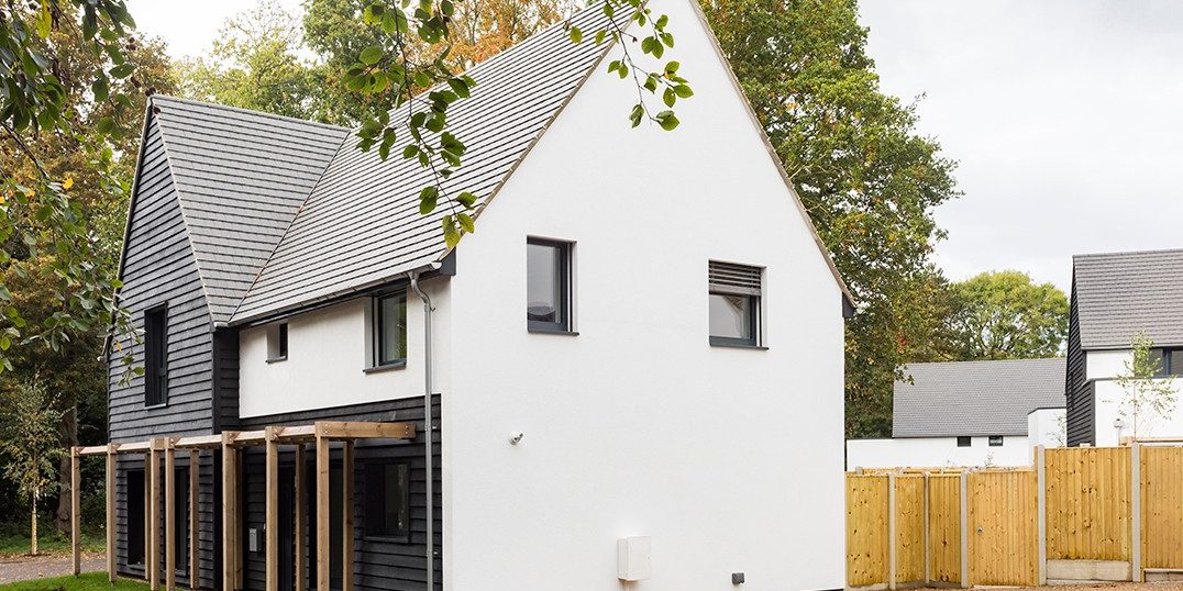 End of modern white house with grey roof