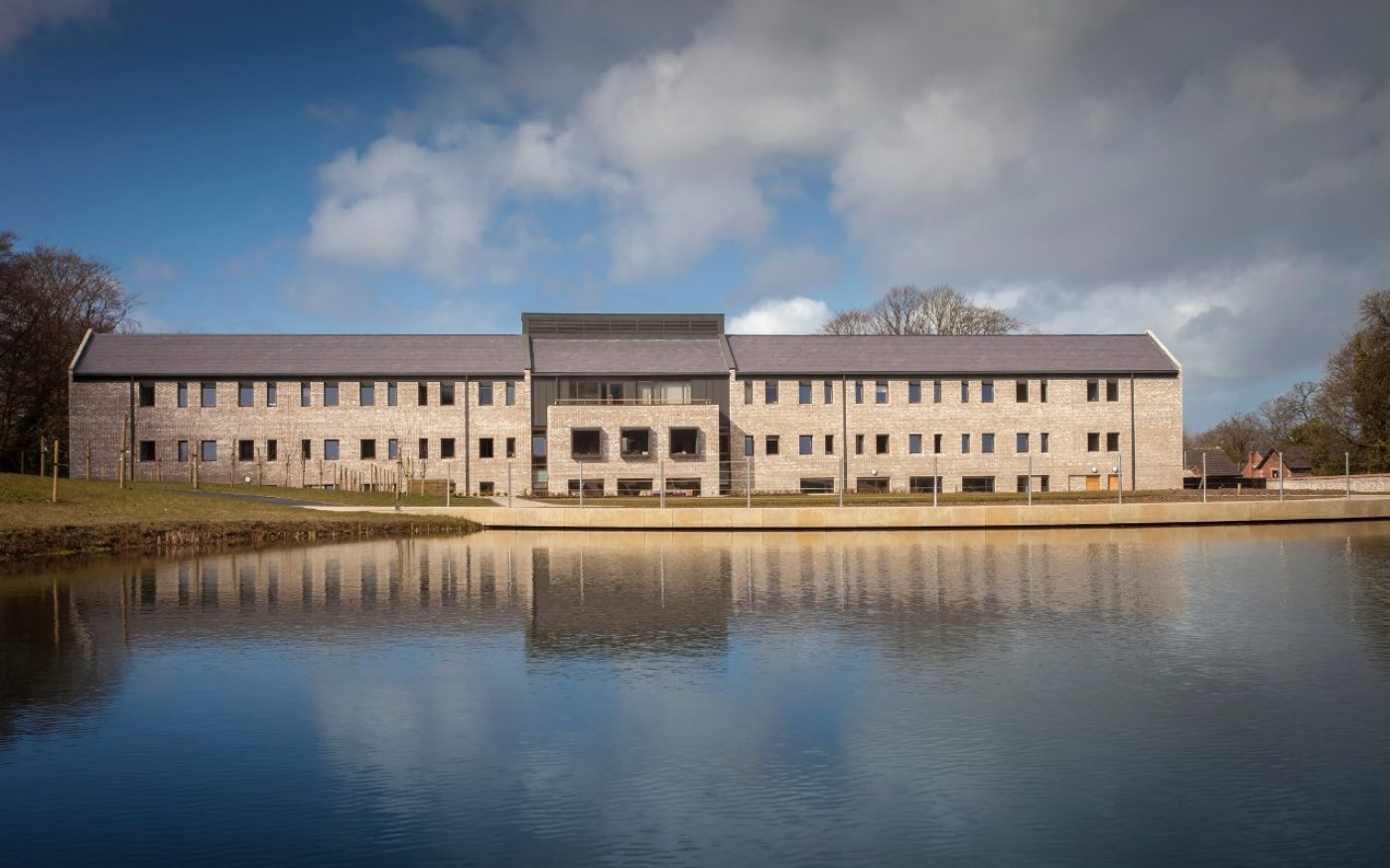 Lake with modern building reflected in it
