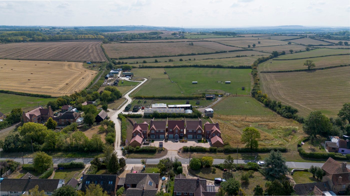 Aerial view of a residential neighbourhood surrounded by lush greenery.