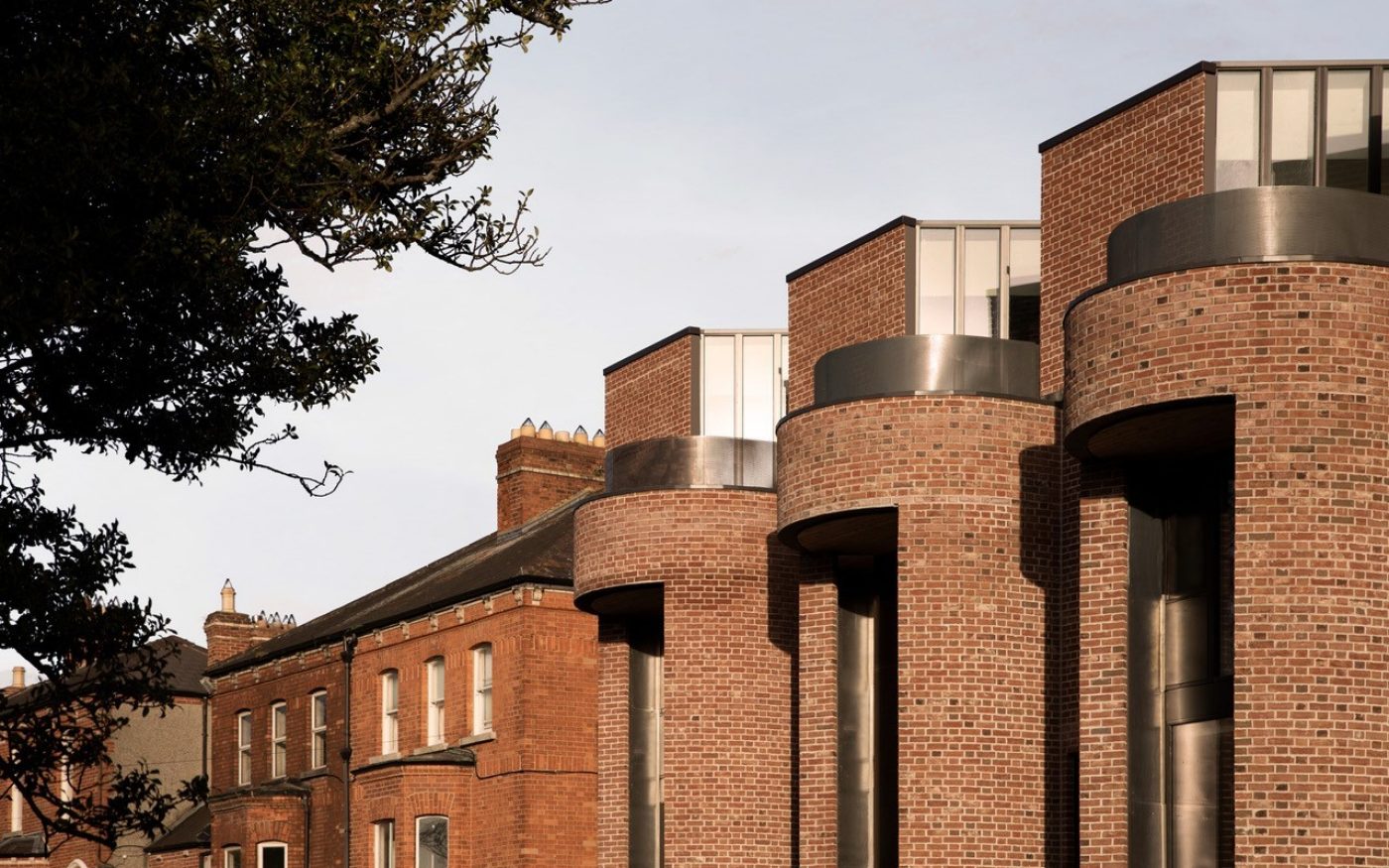 side shot of the four townhouses, showcasing the grand curved windows