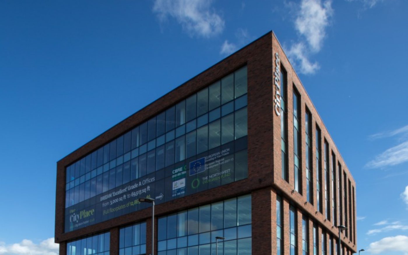Modern square brick building against blue sky