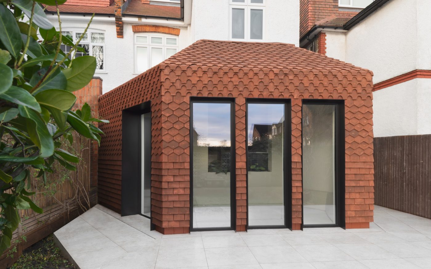 Contemporary design of handmade roof tiles on the facade of an extention