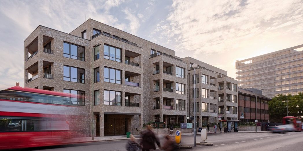 Green glazed bricks at entrance of retail building