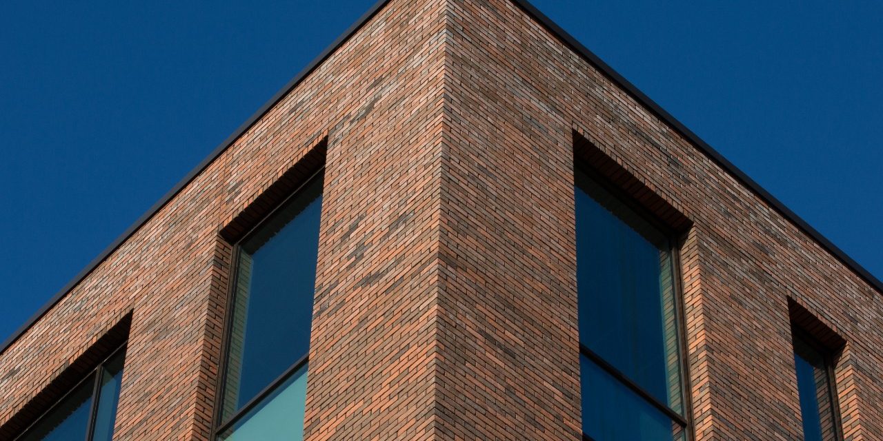 Corner of modern red brick office building