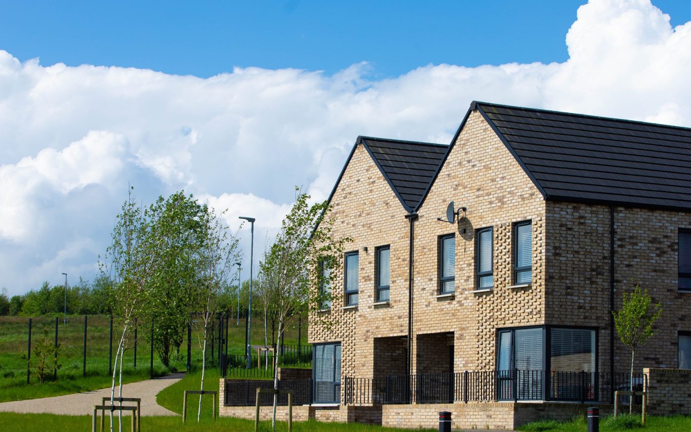 Two semi detached houses with blue sky in the background