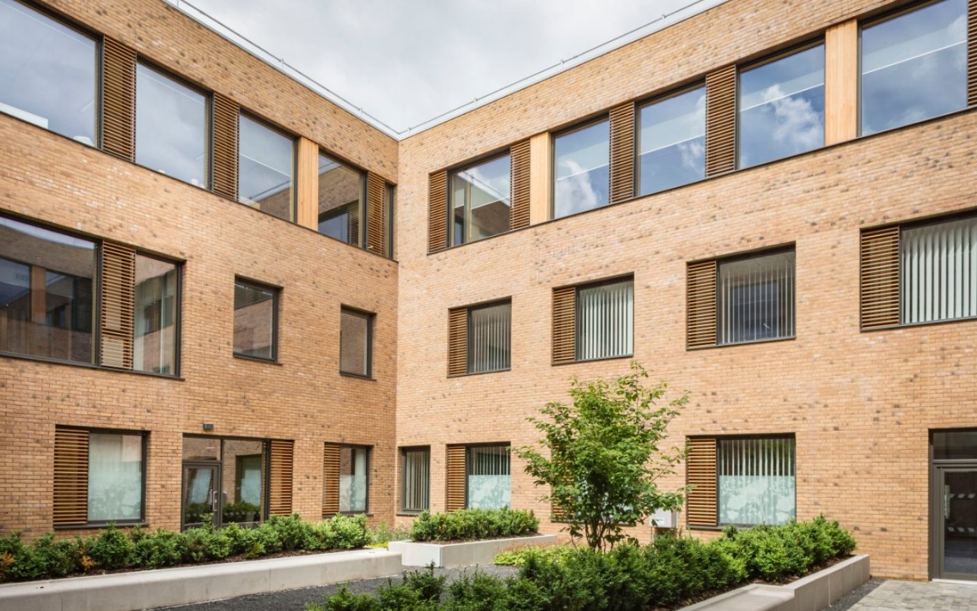 Courtyard of modern brick health centre with large windows