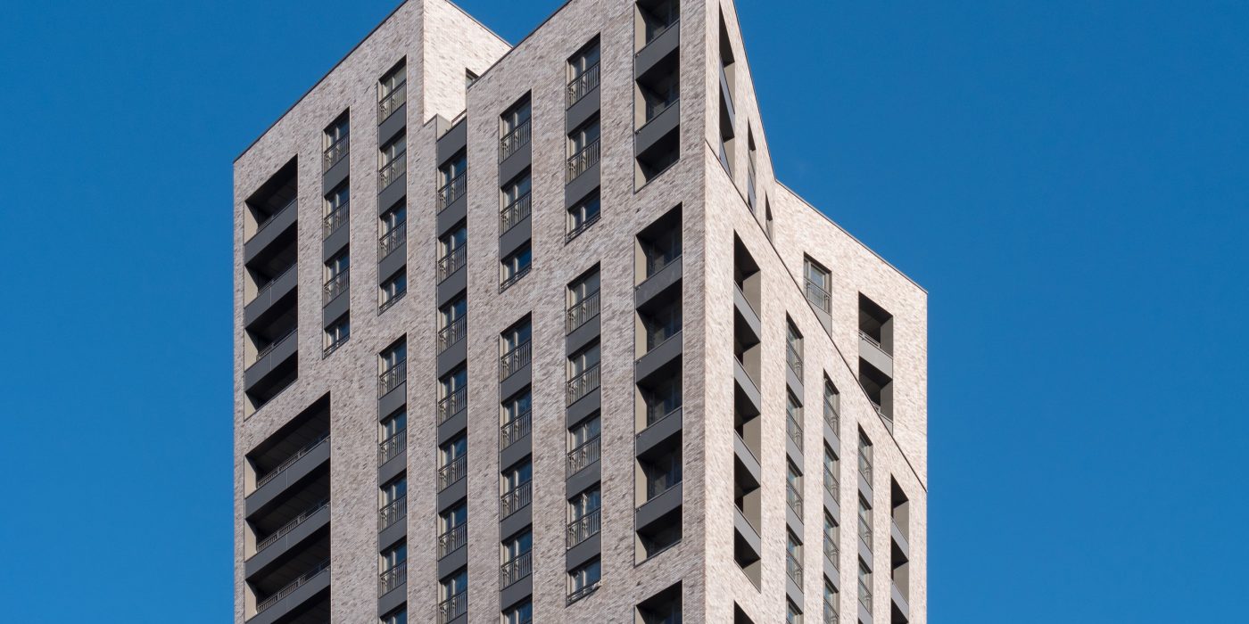 Exterior of modern apartment building against blue sky