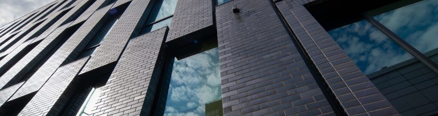 Brick tile facade on modern college building, reflecting sunlight